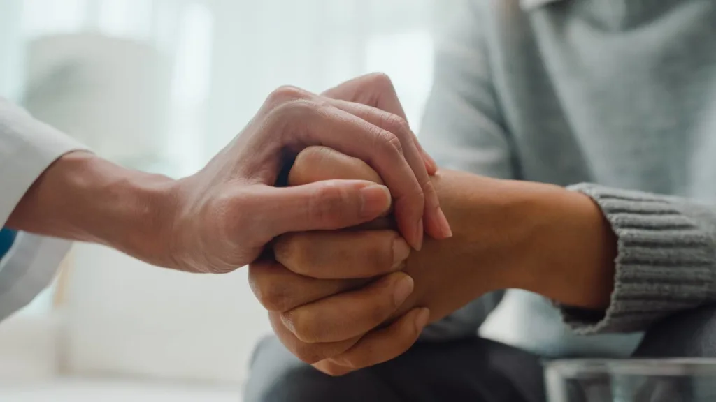 Close up hands of 1:1 trauma-informed coaching session